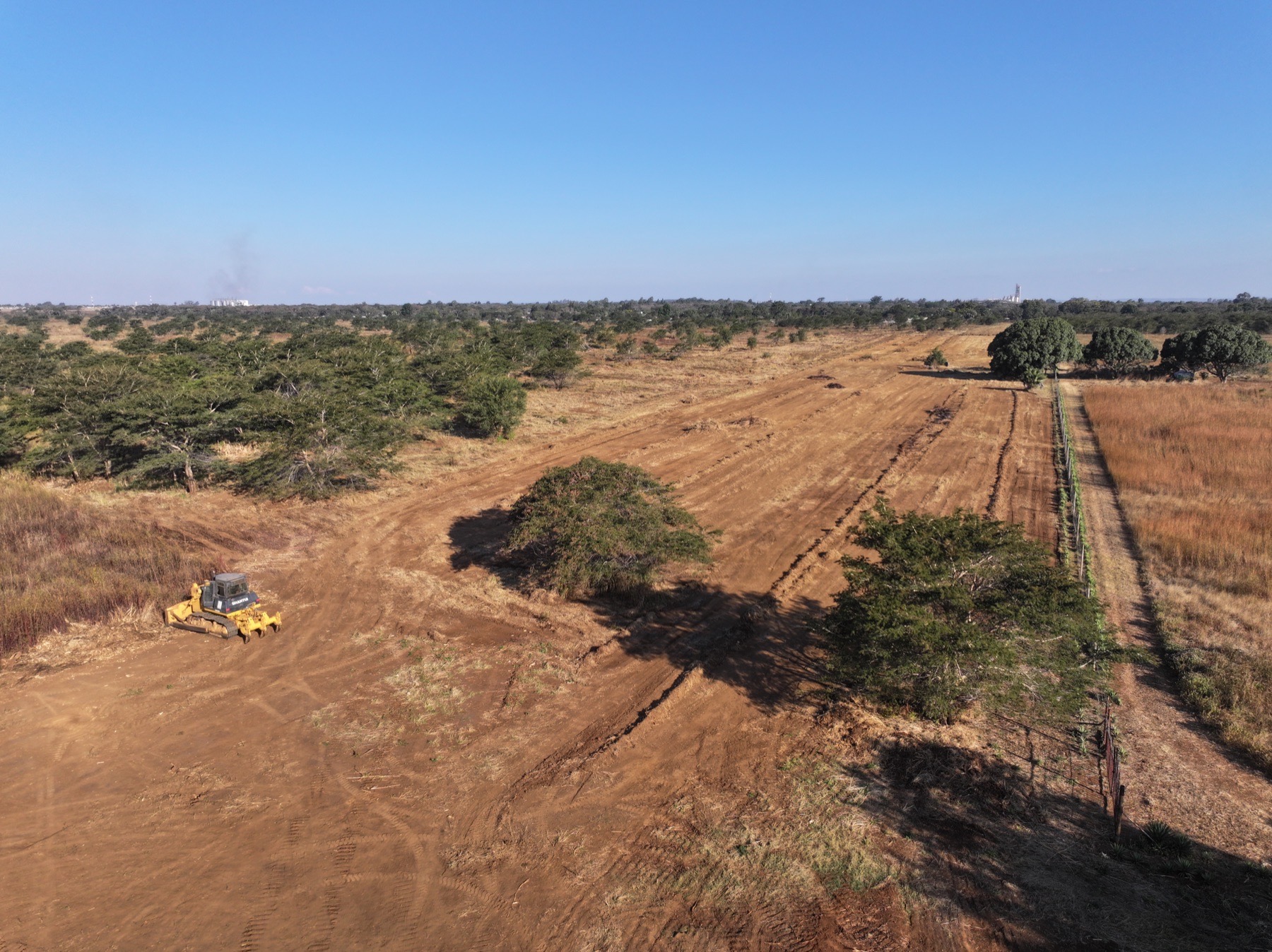 Drone view of land clearing machinery and prepared ground at Parkway City