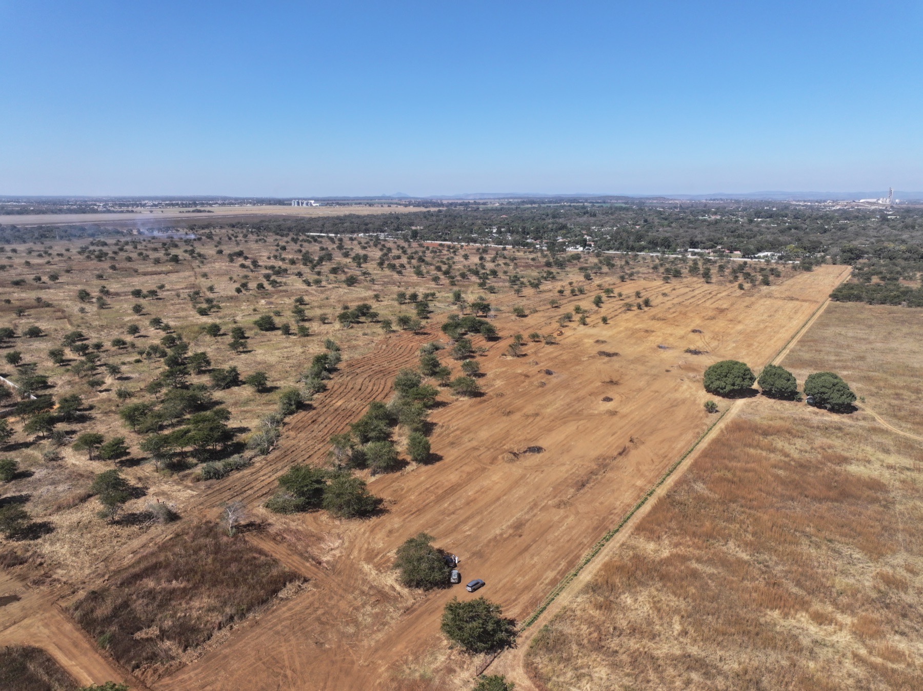 Aerial view of Parkway City land clearing progress with cleared estate roads and surrounding trees